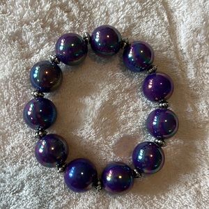 Garold Miller stretch bracelet with silver separators. Incandescent purple